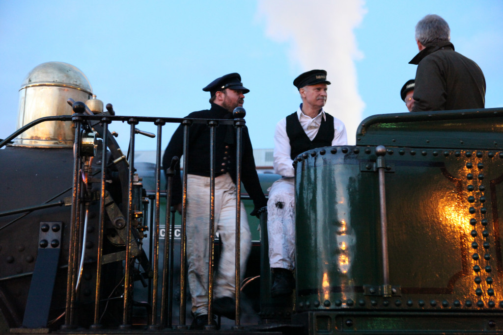Picture of locomotive volunteers chatting on the footplate of Planet.